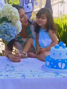 Mother and daughter with baby cake